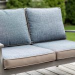Replacement outdoor cushions displayed on a patio loveseat frame in a Canadian backyard setting, showing fabric texture and cushion foam detail.