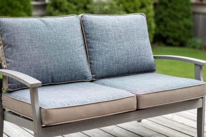 Replacement outdoor cushions displayed on a patio loveseat frame in a Canadian backyard setting, showing fabric texture and cushion foam detail.